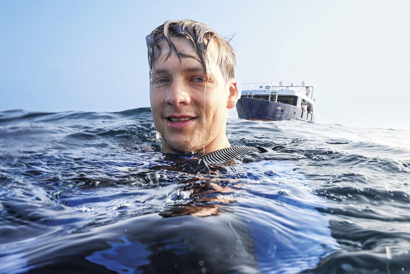 diver on the surface of water 